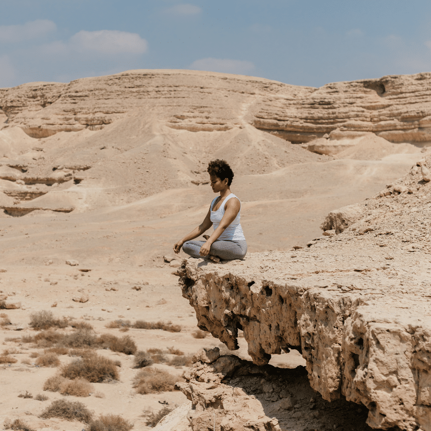 woman meditating in the desert