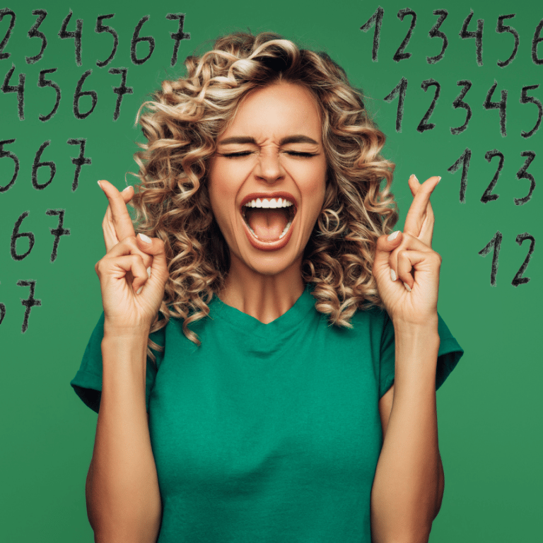 excited woman crossing her fingers for good luck with her eyes closed against a green background with floating numbers