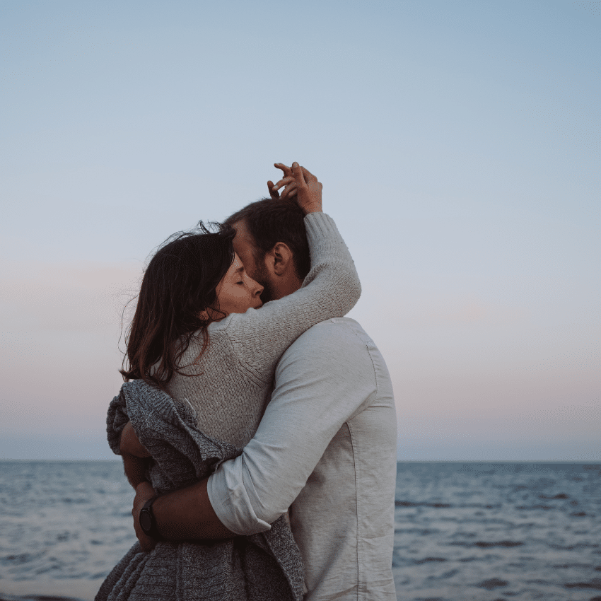 couple on a beach embracing each other