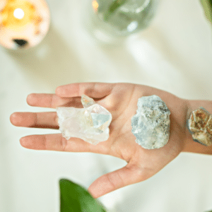 hand extended out holding three different crystals