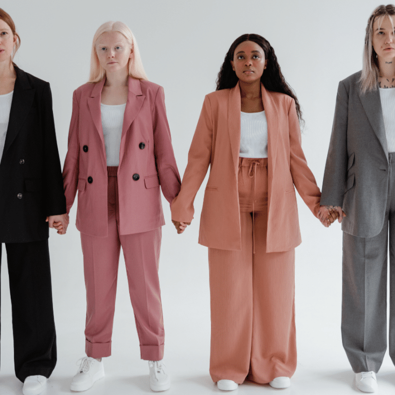 four women in business suits standing together