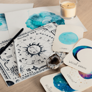 birth chart with a large sun in the middle on a table with astrology cards, pens, and a candle