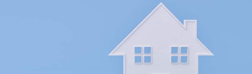 An illustration of a pink house on a light blue background.