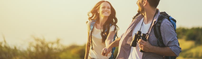 couple-smiling-holding-hands-and-hiking