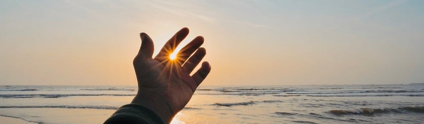 hand-reaching-out-across-ocean