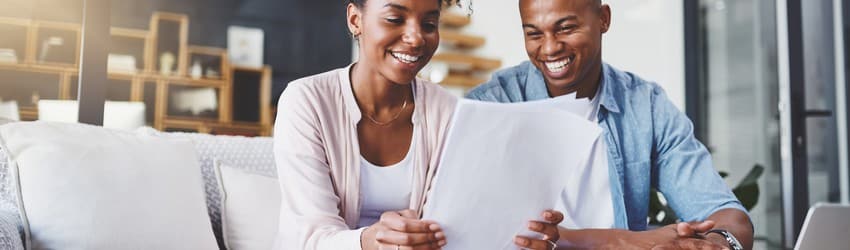 man-and-woman-sitting-on-couch-smiling