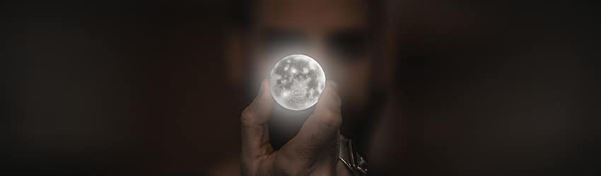 Person holding a full moon in front of their face.