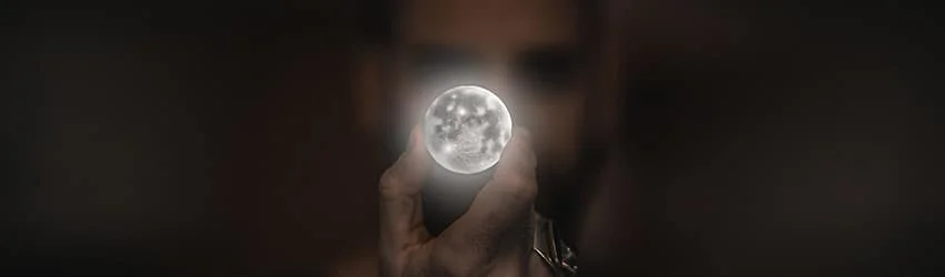 Person holding a full moon in front of their face.