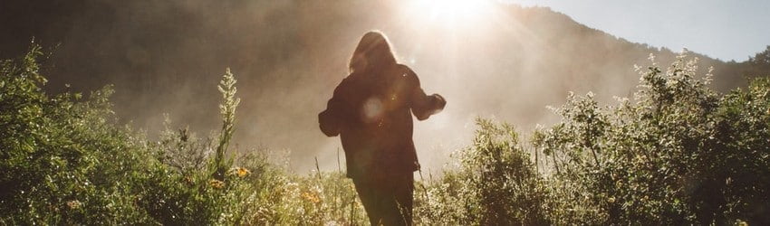 silhouette-of-woman-running-through-a-field