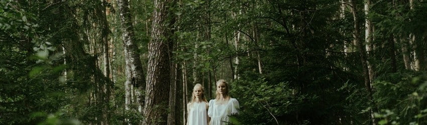 twins-in-forest-surronded-by-trees