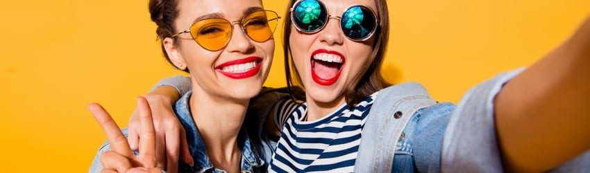 two girls in funky outfits smiling