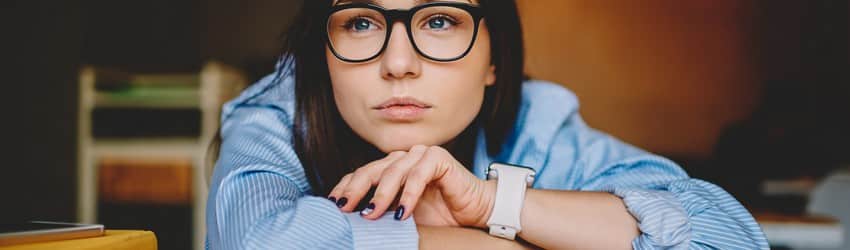 woman-with-glasses-on-in-deep-thought