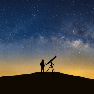 man with a telescope starring up at the blue and yellow starry night