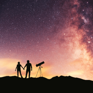 couple holding hands gazing at the stars