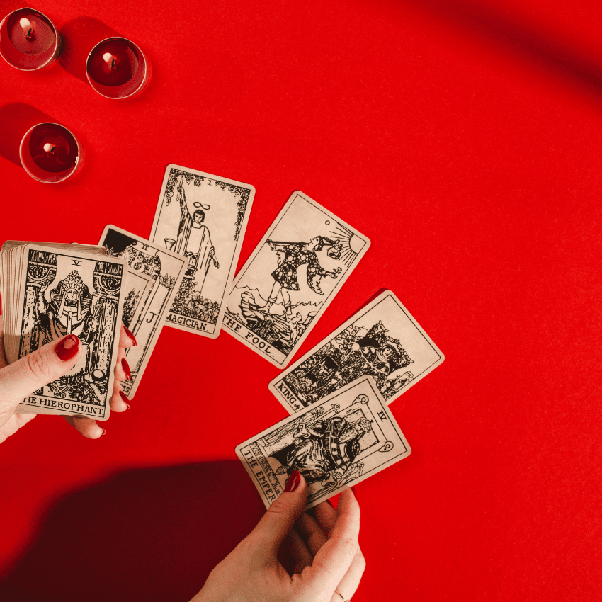 hands holding a set of tarot cards