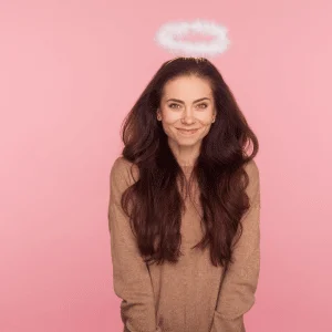 smiling brunette woman with an angel halo above her head