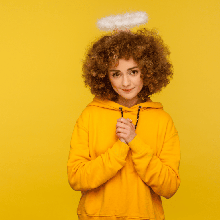 woman in a yellow hoodie with a white halo above her head