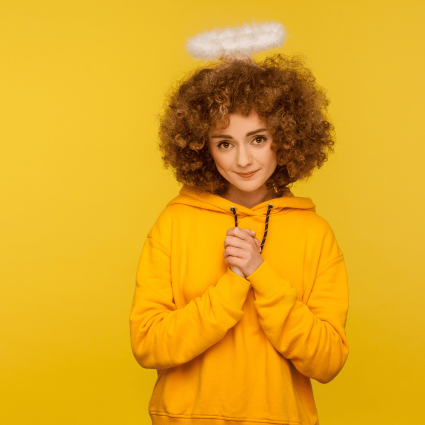 woman in a yellow hoodie with a white halo above her head
