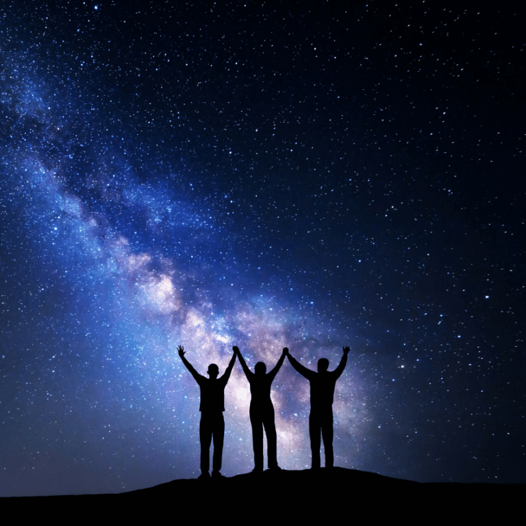 three people with their hands in the air against a blue and purple starry night