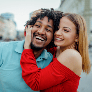 couple embracing each other and smiling happily