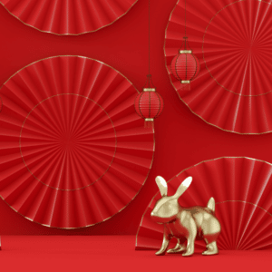 golden rabbit statue against a red background