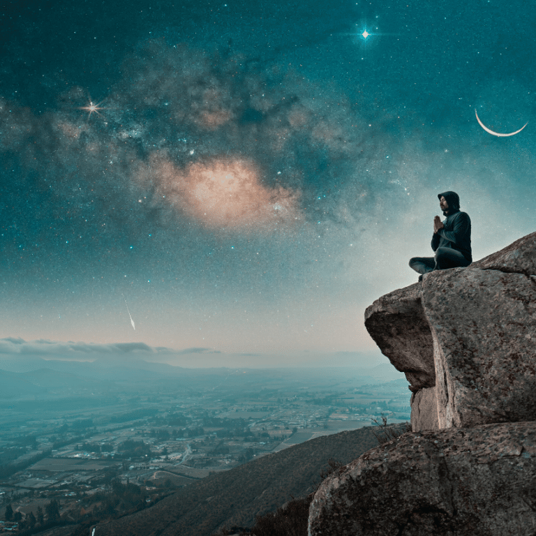 man meditating on a cliff above a city with a blue starry night above him