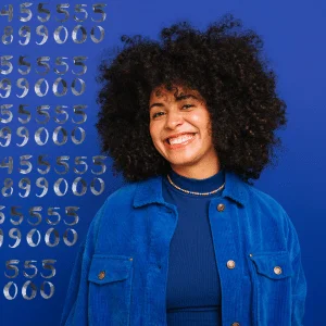 joyful woman with a lush afro in blue with numbers floating in the background