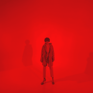 man in all red standing against a red backdrop