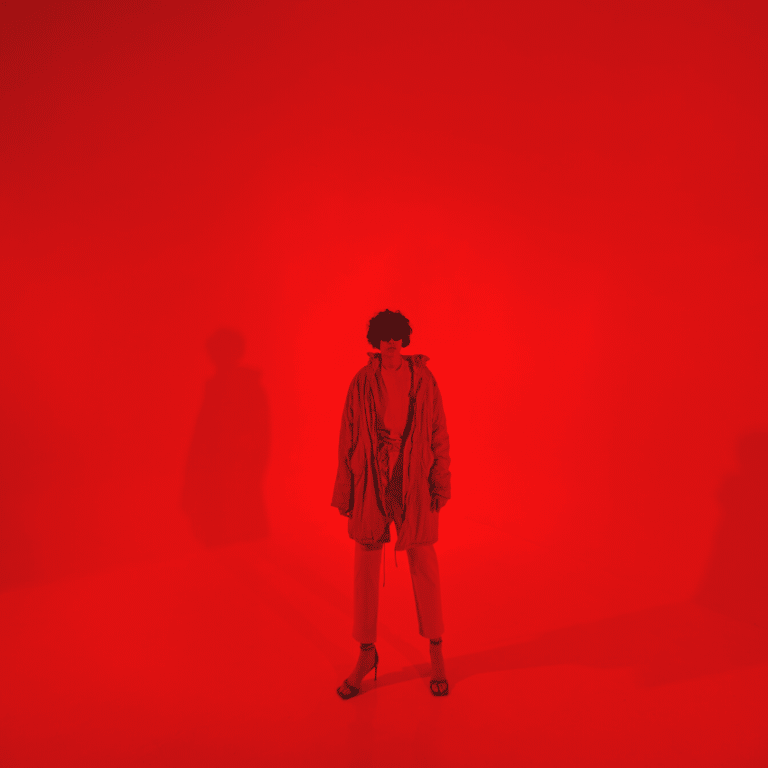 man in all red standing against a red backdrop