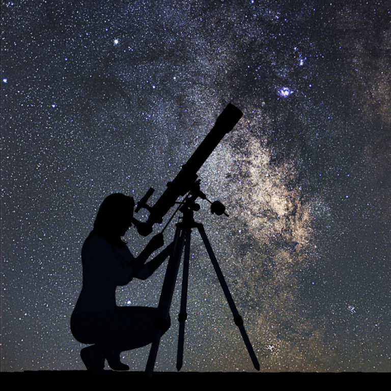 silhouette of a woman bending down to look out of a telescope toward a grey and blue starry sky