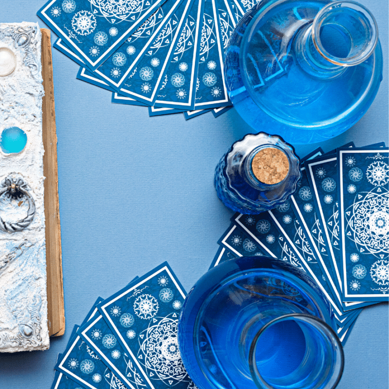 an array of blue tarot cards spread out on a blue table