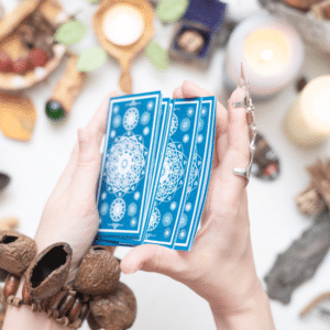 pair of hands shuffling blue tarot cards
