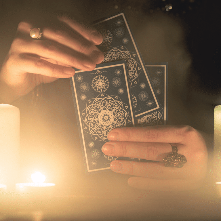 pair of hands shuffling three blue tarot cards