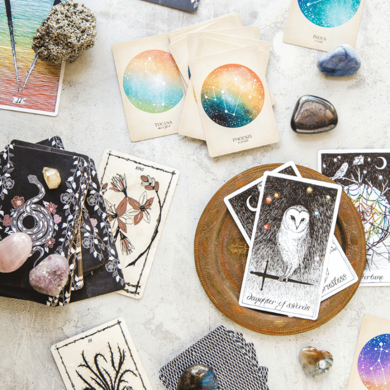 array of different tarot cards spread out on a white table