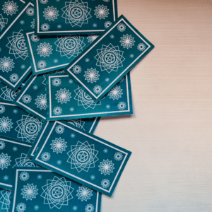 blue tarot cards spread out on a white table