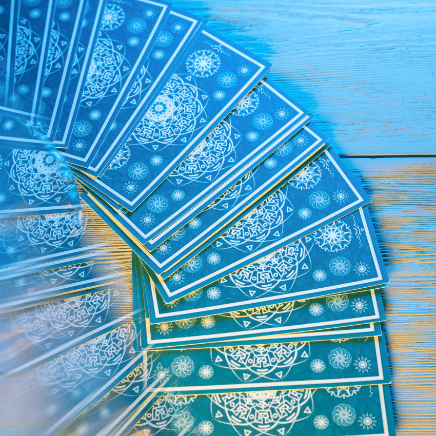 array of blue tarot cards spread out on a table