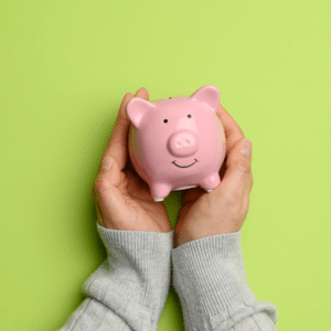 pair of hands holding a piggybank