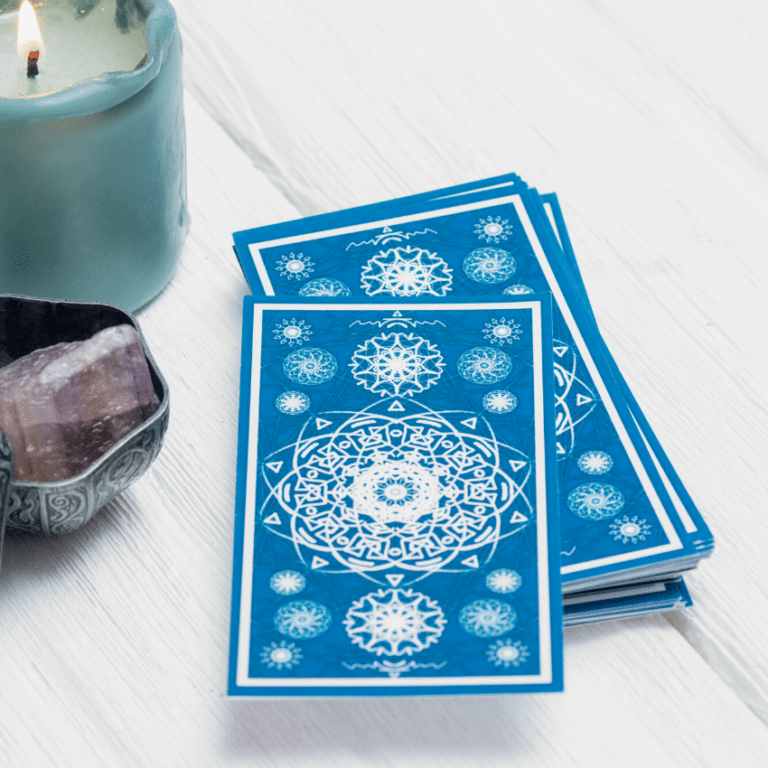 stack of blue tarot cards on a wooden table