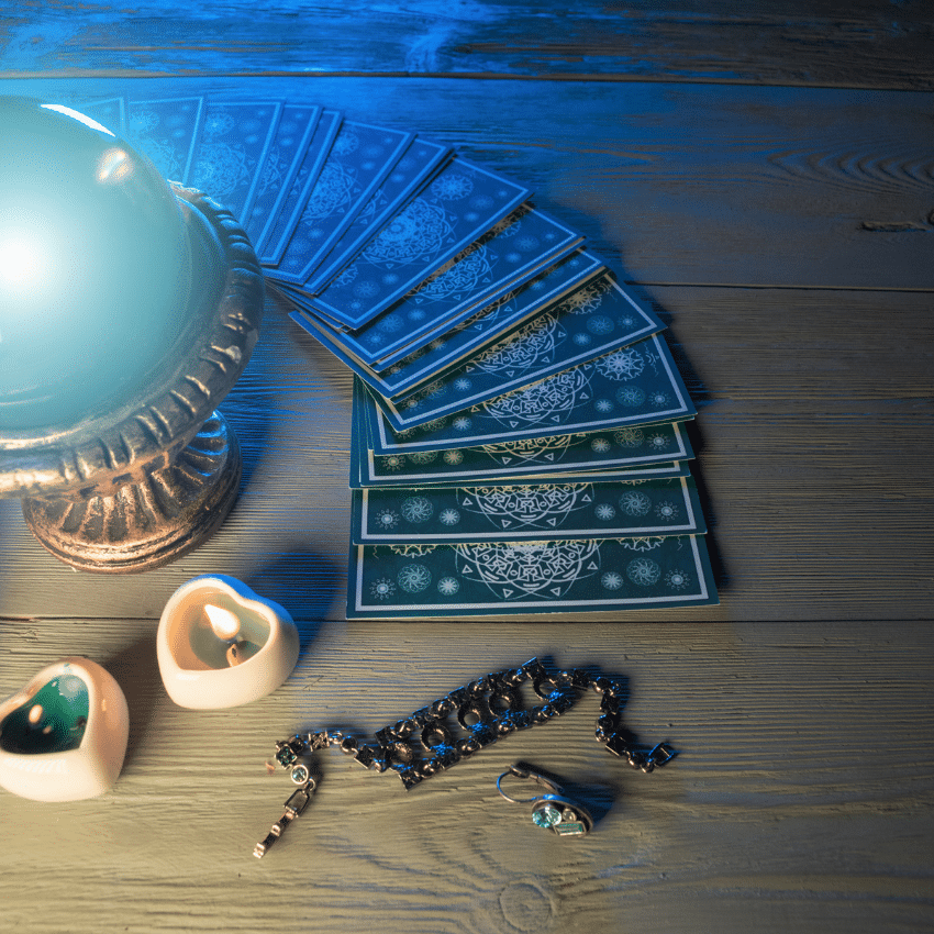 blue tarot cards spread out on a wooden table