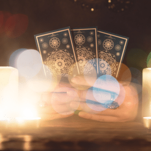 pair of hands holding up three blue tarot cards