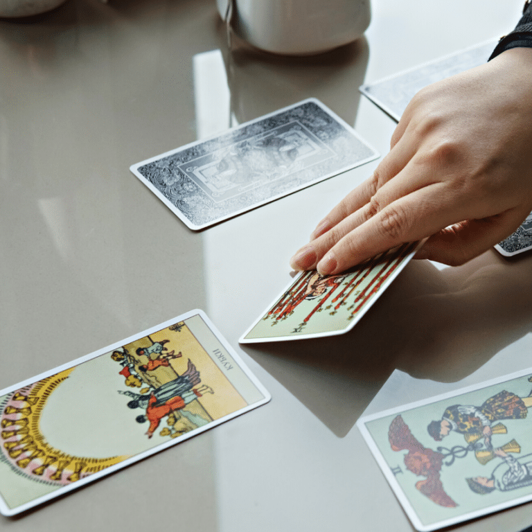hand shuffling tarot cards with the 10 of cups shown