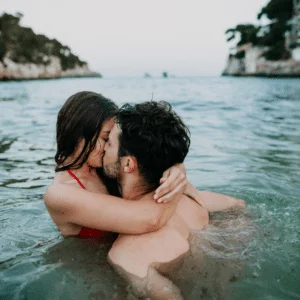 couple in the ocean embracing and kissing