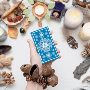 hand holding out a blue tarot card