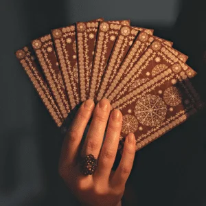 pair of hands holding up brown tarot cards