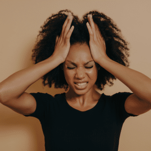 woman with her hands on her head looking distressed