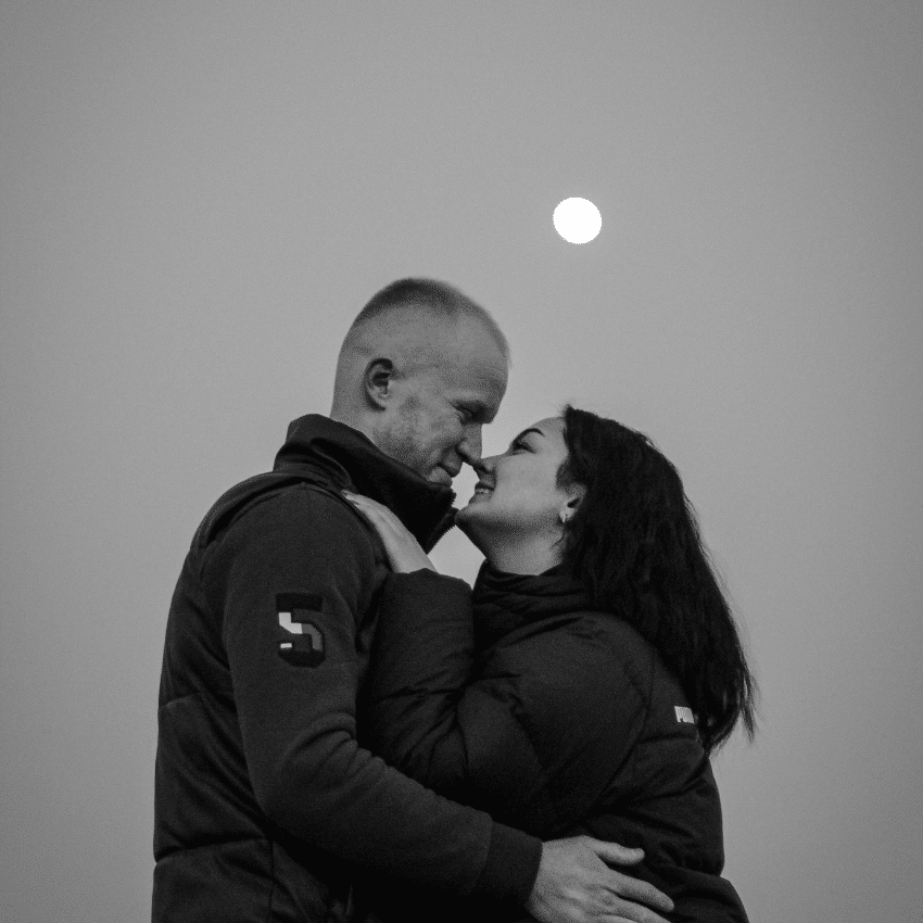 A couple embraces under a Full Moon