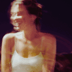 A blurred image of a woman similing to encapsulate the energy of the month ahead.