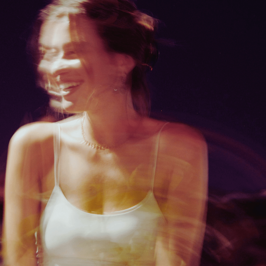 A blurred image of a woman similing to encapsulate the energy of the month ahead.
