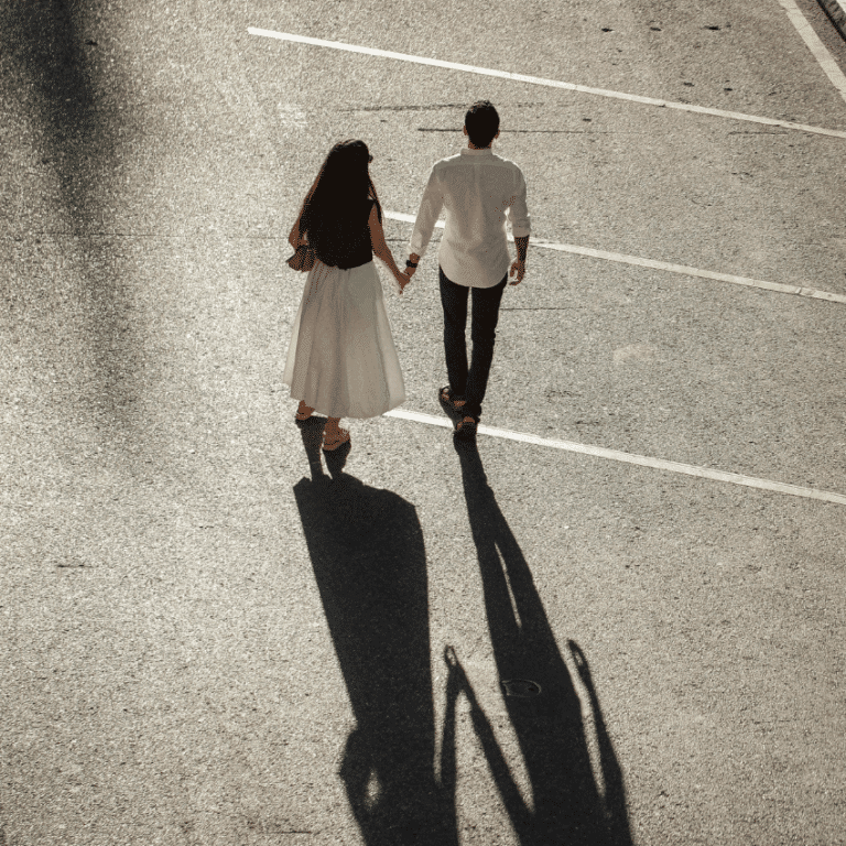 A far away photo of a couple holding hands.