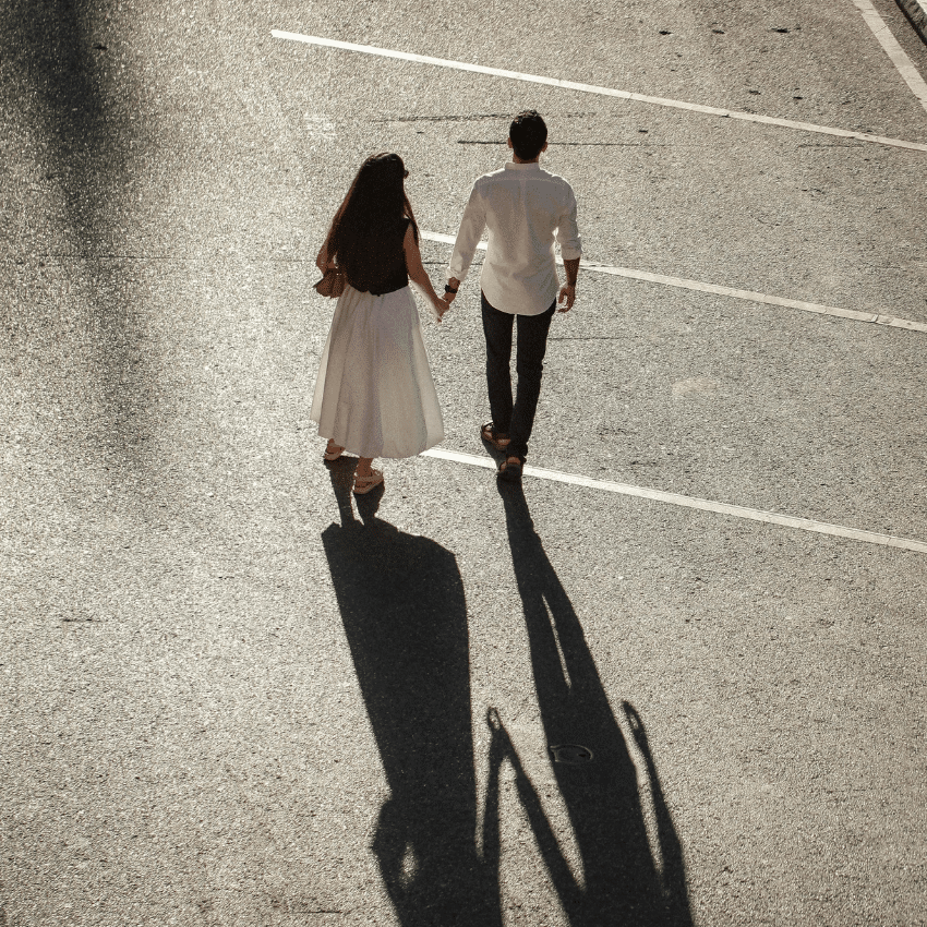 A far away photo of a couple holding hands.